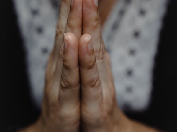 Close-up of a person's hands in a specific yoga mudra gesture.